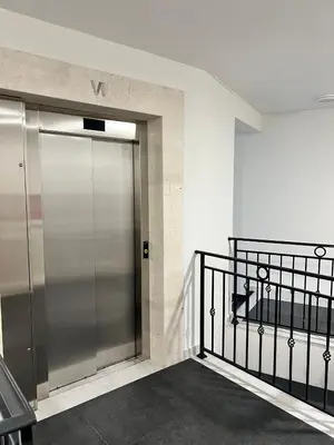 a metal elevator door in a building at Montenegro Prestige Suite in Podgorica
