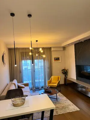 a living room with a couch and a table at Montenegro Prestige Suite in Podgorica