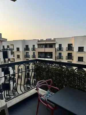 a balcony with a table and chairs and a building at Montenegro Prestige Suite in Podgorica