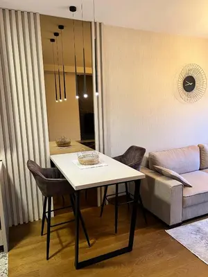 a living room with a table and a couch at Montenegro Prestige Suite in Podgorica