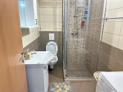 a bathroom with a shower and a toilet and a sink at Apartman T&T in Cetinje
