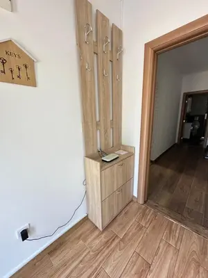 a room with wooden cabinets and a wooden floor at Apartman T&T in Cetinje