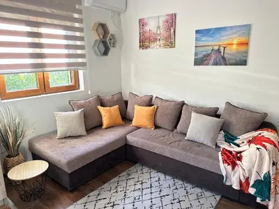 a living room with a couch and a table at Apartman T&T in Cetinje