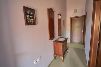 a room with a wooden cabinet and a hallway at Apartman Sveti Stefan in Sveti Stefan