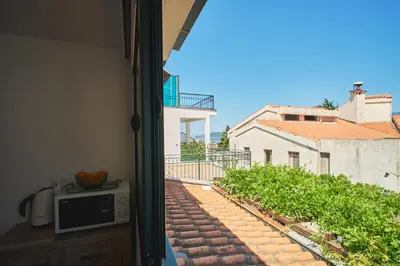 a view of a balcony from a room with a window at Apartman Sveti Stefan in Sveti Stefan