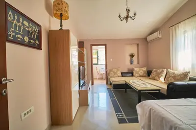a living room with a couch and a table at Apartman Sveti Stefan in Sveti Stefan