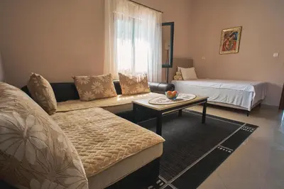 a living room with a couch and a table at Apartman Sveti Stefan in Sveti Stefan