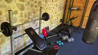 a room with a gym with weights and a punching bag at Castio del Monte Winery & Resort in Petrovac na Moru