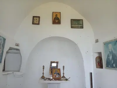 a white room with a shelf and pictures on the wall at Castio del Monte Winery & Resort in Petrovac na Moru