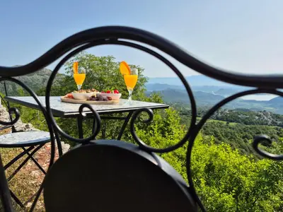 a table with two glasses of orange juice on it at Castio del Monte Winery & Resort in Petrovac na Moru
