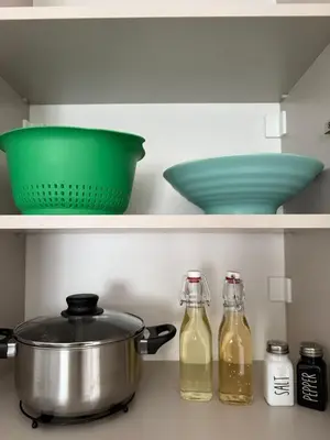 a kitchen with two bowls and a pot and two bottles at Cloud 9 Apartment in Lajkovići