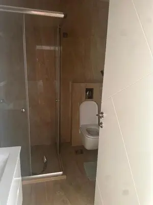 a bathroom with a toilet and a glass shower at Ars Dobra Voda in Dobra Voda