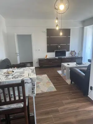 a living room with a couch and a table at Ars Dobra Voda in Dobra Voda