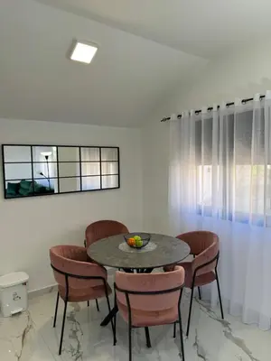 a dining room with a table and chairs at CASA HOME, one-bedroom home in Stanišiči