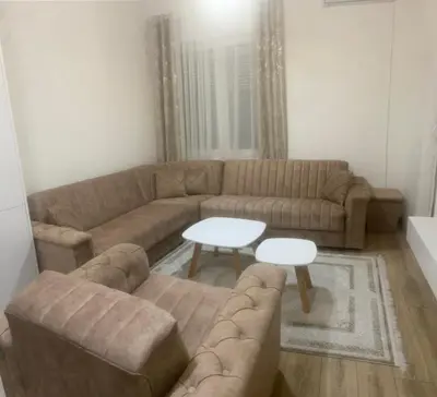a living room with a couch and a table at L&D Apartments in Ulcinj