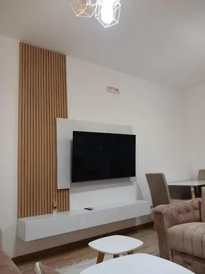 a living room with a flat screen tv on a wall at L&D Apartments in Ulcinj