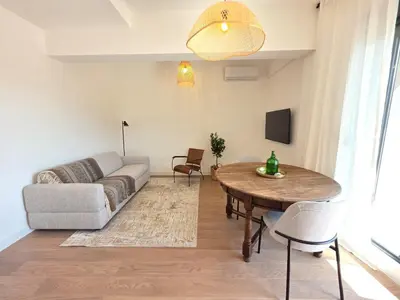 a living room with a couch and a table at Laurel apartment in Kravlja