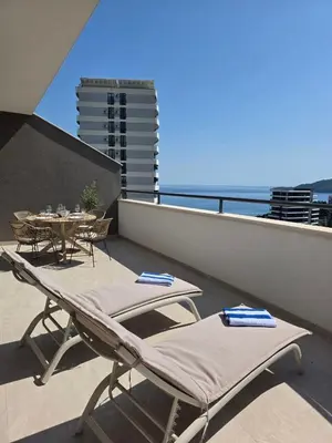 a patio with chairs and a table on a balcony at Laurel apartment in Kravlja
