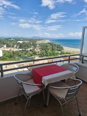 a table and chairs on a balcony with a view of the ocean at Aparments Plaza in Velika Plaža