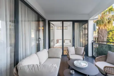 a living room with a white couch and a table at Olive Apartment in Sveti Stefan