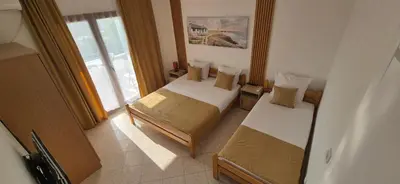 a hotel room with two beds and a window at Apartments Plaza in Ulcinj