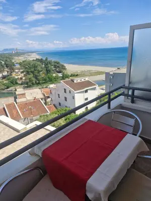 a balcony with a bed and a view of the ocean at Apartments Plaza in Ulcinj