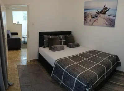 a bedroom with a bed and a picture on the wall at Tea23 in Kotor