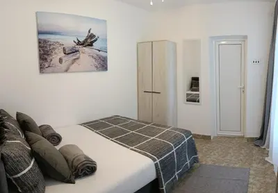a bedroom with a bed and a refrigerator at Tea23 in Kotor