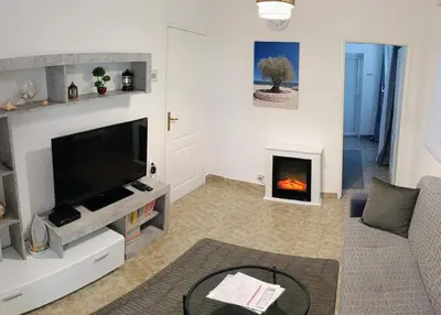 a living room with a tv and a fireplace at Tea23 in Kotor