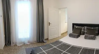 a bedroom with a bed and a window at Tea23 in Kotor