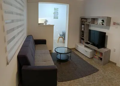 a living room with a couch and a television at Tea23 in Kotor