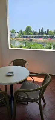 a table and two chairs and a table and a window at Hotel Porto Otrant in Ulcinj