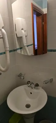 a bathroom with a sink and a mirror at Hotel Porto Otrant in Ulcinj