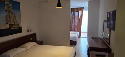 a hotel room with a bed and a window at Hotel Porto Otrant in Ulcinj