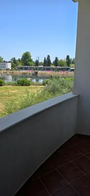 a balcony with a view of a field and a train at Hotel Porto Otrant in Ulcinj