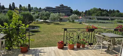 a balcony with a table and potted plants at Hotel Porto Otrant in Ulcinj
