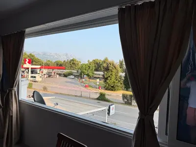 a window with a view of a gas station at Emines apartman Budva in Budva