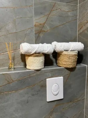a bathroom with two baskets and an electrical outlet at LazArina Apartments in Bar