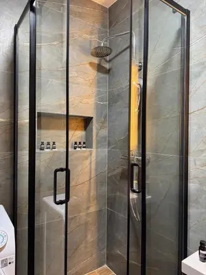 a shower with a glass door in a bathroom at LazArina Apartments in Bar