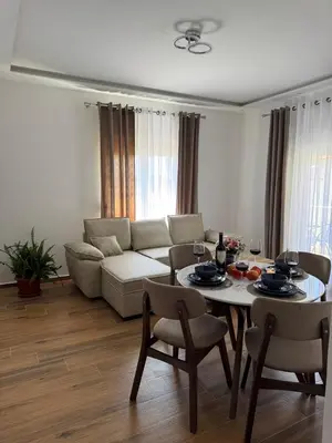 a living room with a table and a couch at LazArina Apartments in Bar