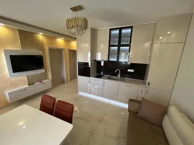 a living room with a white table and a tv at Vista Boka New Luxury Apartment in Kotor in Kotor