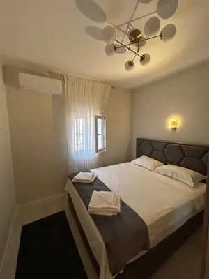 a bedroom with a large bed with a ceiling at Vista Boka New Luxury Apartment in Kotor in Kotor