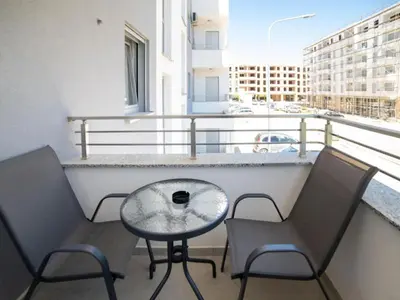 a balcony with two chairs and a table on a balcony at Nikola apartmani in Ulcinj