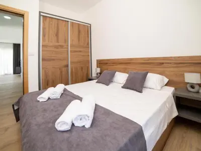 a bedroom with two beds with white towels on them at Nikola apartmani in Ulcinj
