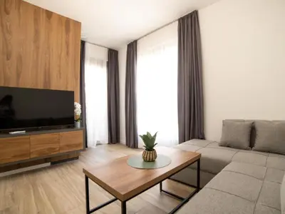 a living room with a couch and a tv at Nikola apartmani in Ulcinj