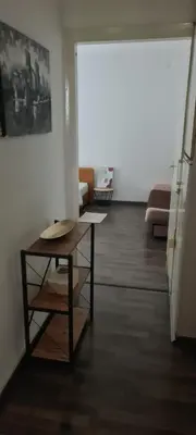 a living room with a table and a couch at Coco Apartment in Dobrota