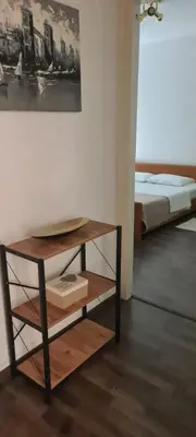 a room with a table with a bed in the background at Coco Apartment in Dobrota