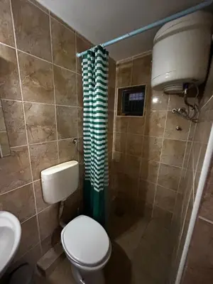 a bathroom with a toilet and a shower at Apartmani Musić in Ulcinj