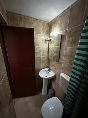 a bathroom with a sink and a toilet and a mirror at Apartmani Musić in Ulcinj