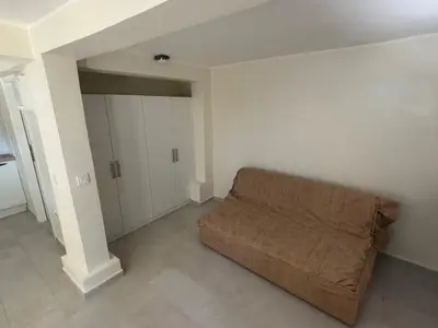 a living room with a couch in the corner at studio Oliva home in Utjeha